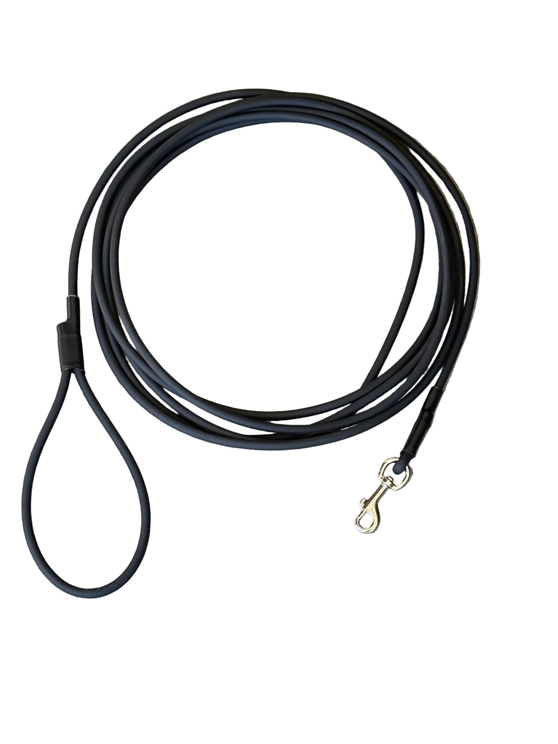 A black biothane dog lead rope with a large loop handle and a metal snap hook, coiled on a textured white background.