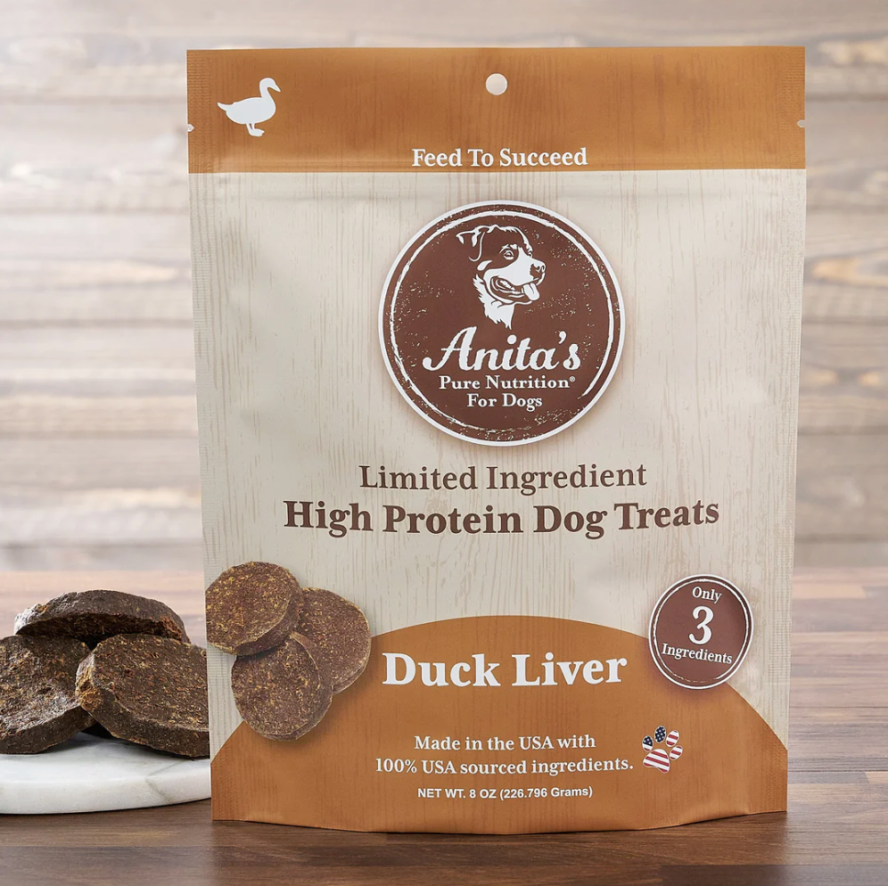 Package of Anita's Pure Nutrition dog treats with visible treats in front, indicating Duck Liver flavor, and text stating Limited Ingredient High Protein Dog Treats.
