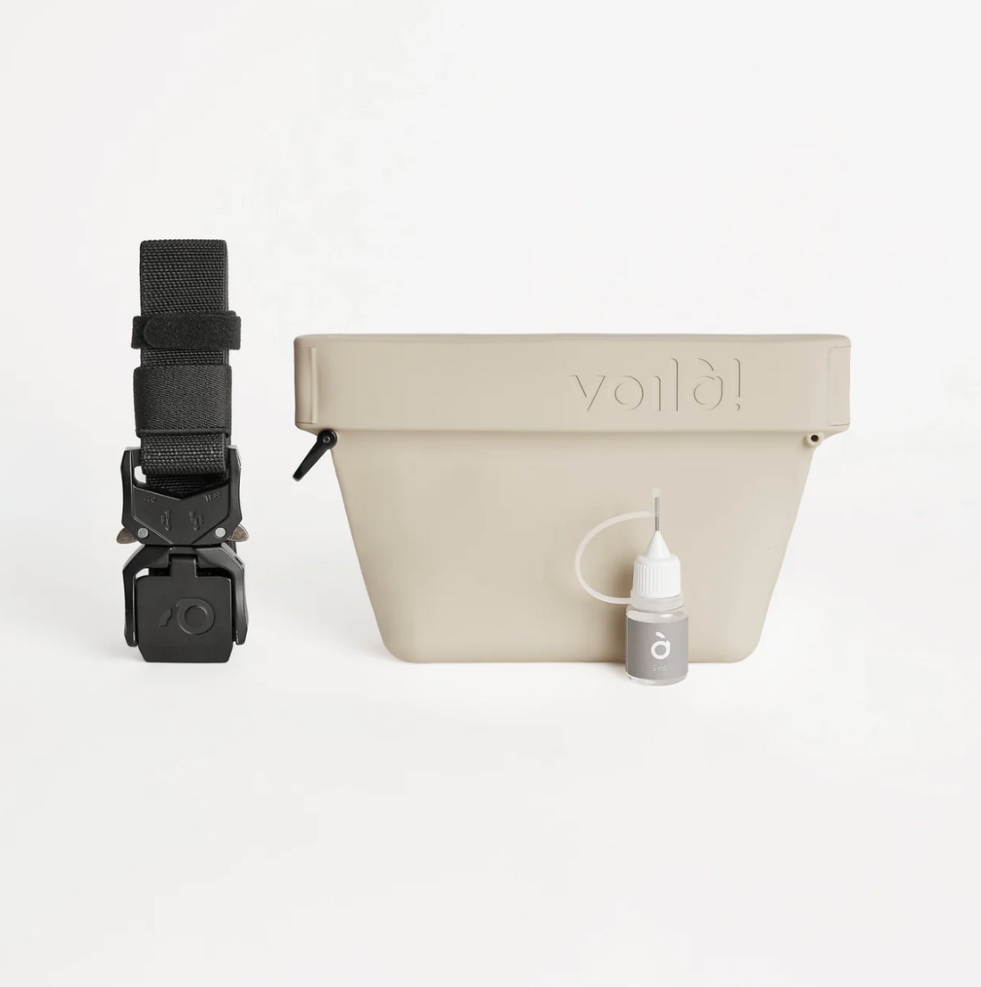 Off-white pet training treat bag with black strap and small bottle of oil on a white background.