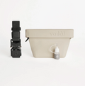 Off-white pet training treat bag with black strap and small bottle of oil on a white background.