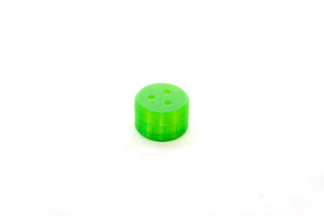 A green mini magnetic hide vessel with three perforations designed for scent detection training exercises for dogs.