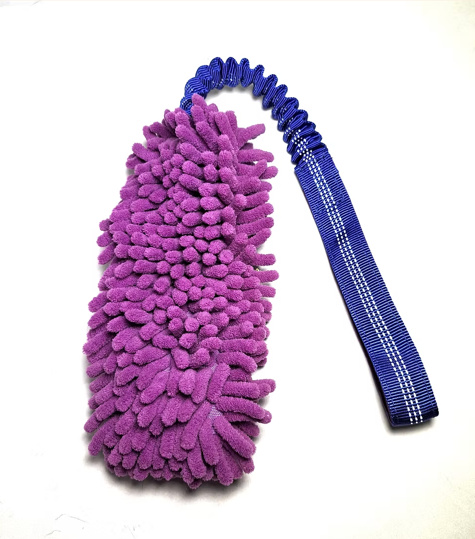 Green microfiber cleaning mitt with purple handle on a white background.