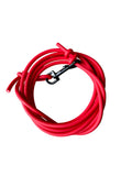 A coiled bright red leash with a black metal clip