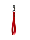 Red dog leash with metal clip on a white background.