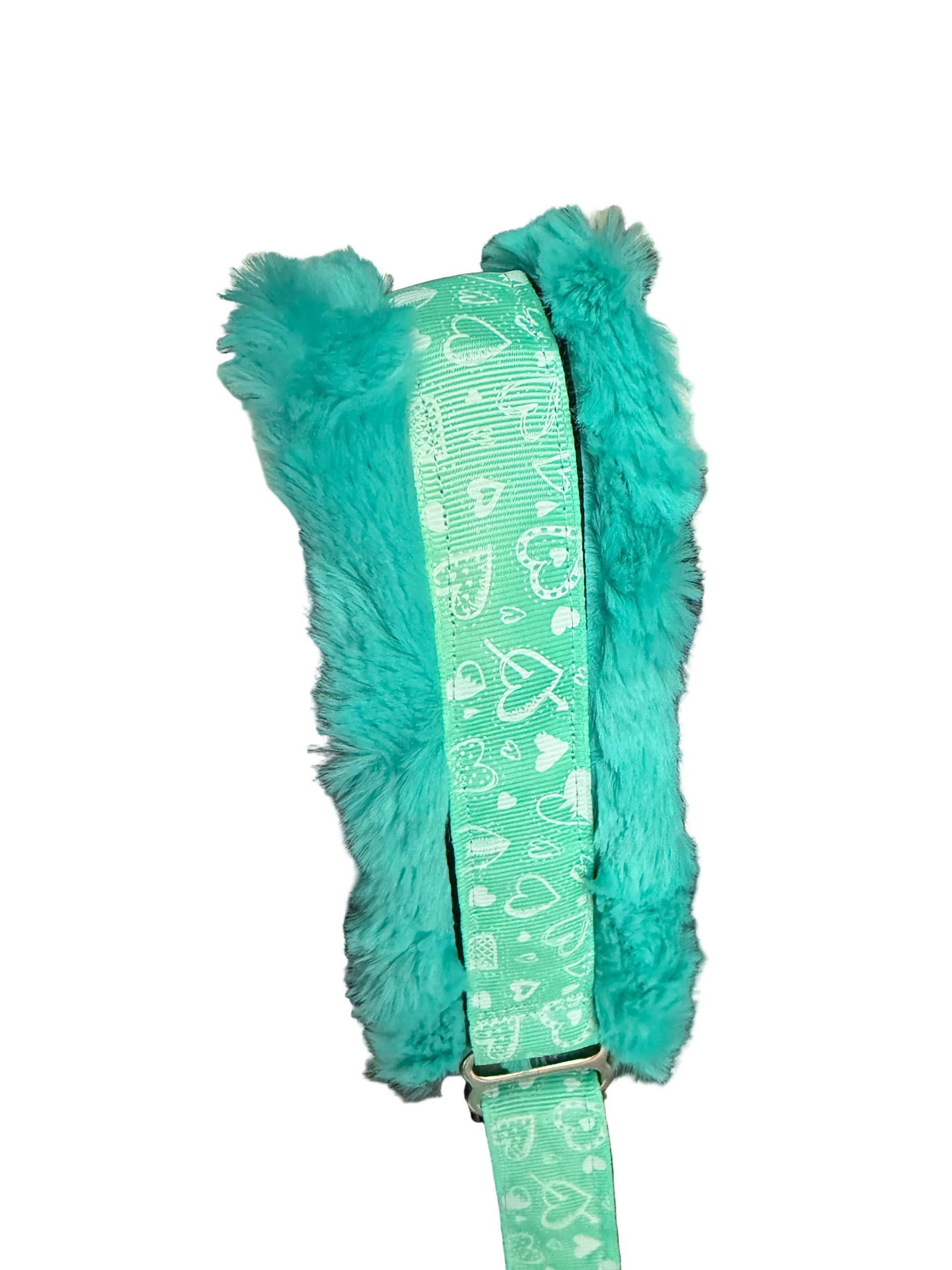 Turquoise strap with heart patterns.