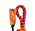 Colorful fluffy collar with a leash on a white background.