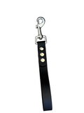 Black leather dog leash with metal clip on a white background.